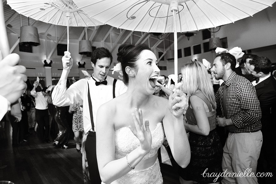Bride and groom dancing with parasols second line, wedding by Bray Danielle Photography