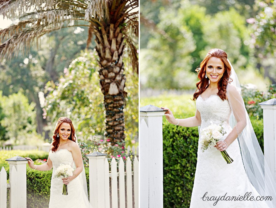 bride standing by pickett fence and palm tree by Bray Danielle Photography 