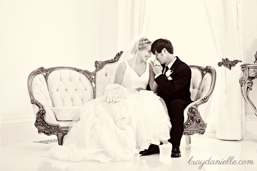 beautiful bride and groom sitting on couch