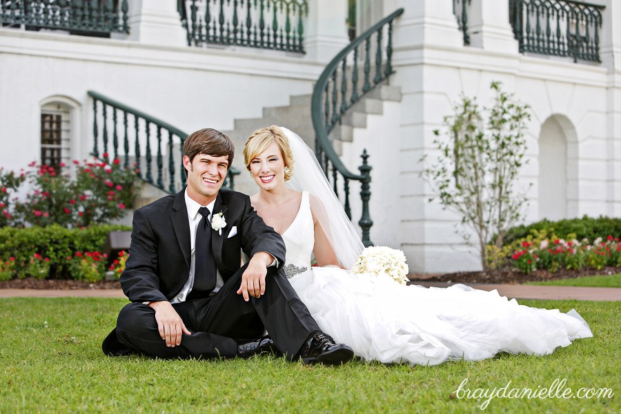 portrait of bride and groom sitting outside