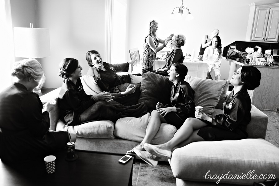 Wedding candid photo of bridal party sitting on couch