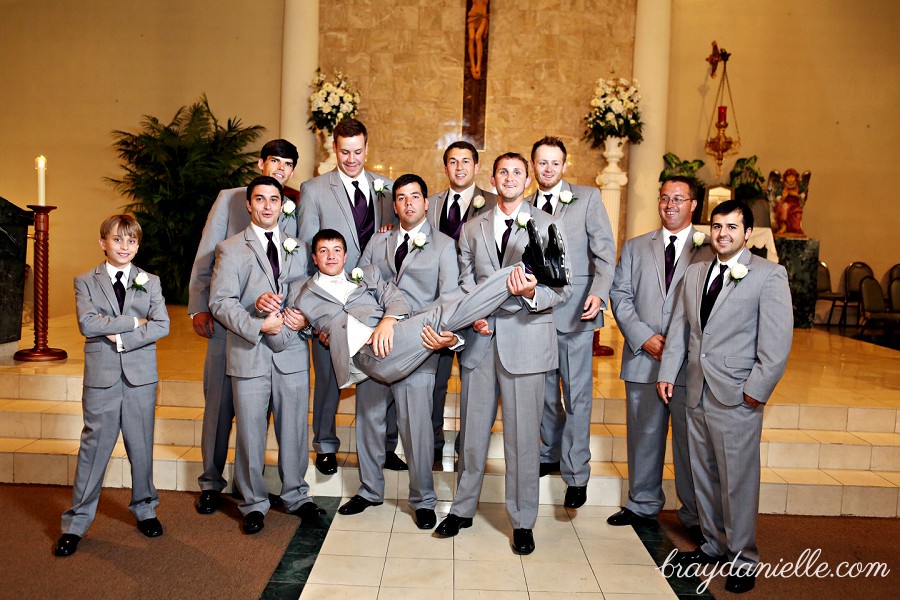 Fun groomsmen holding up groom