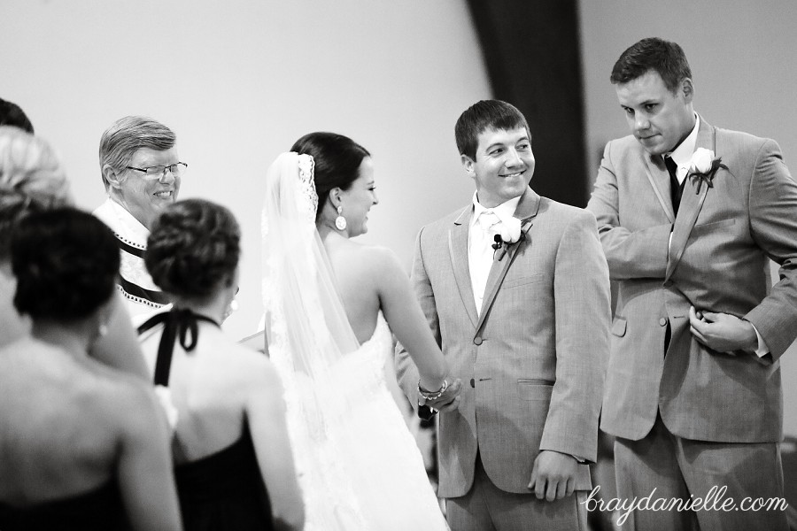 bride and groom holding hands during ceremony