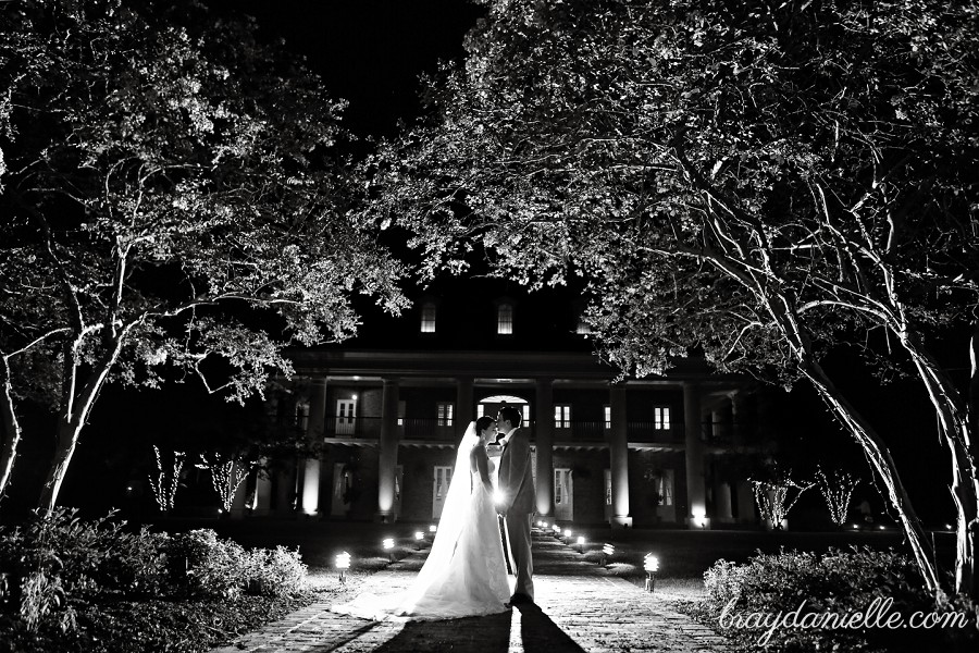 beautiful outside silhouette of bride and groom in front of planation home