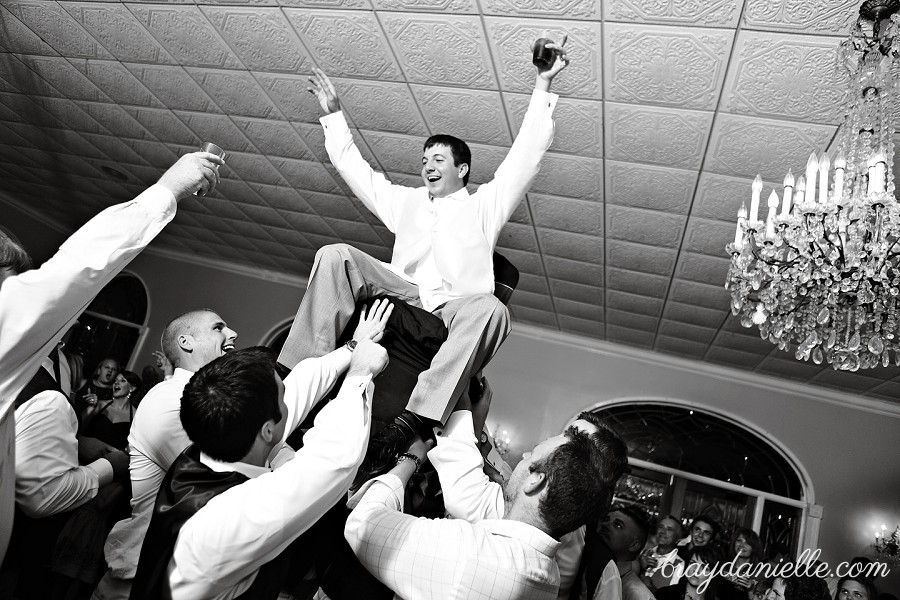 groom lifted up in chair