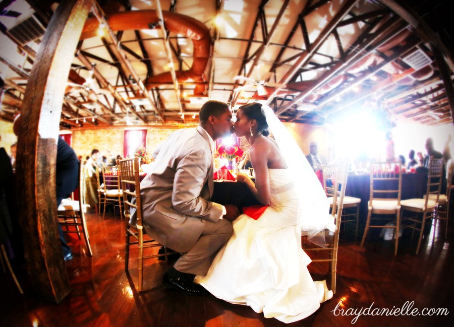 bride and groom kissing while seated