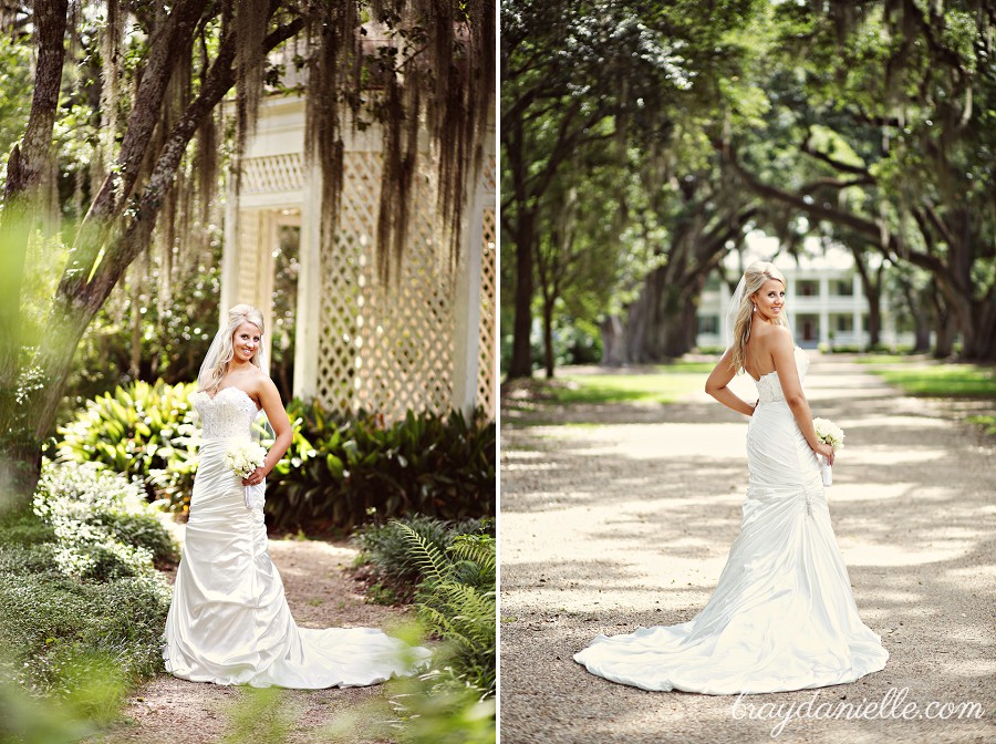 Bride standing under Mossy oak + in front of mansion by Bray Danielle Photography 