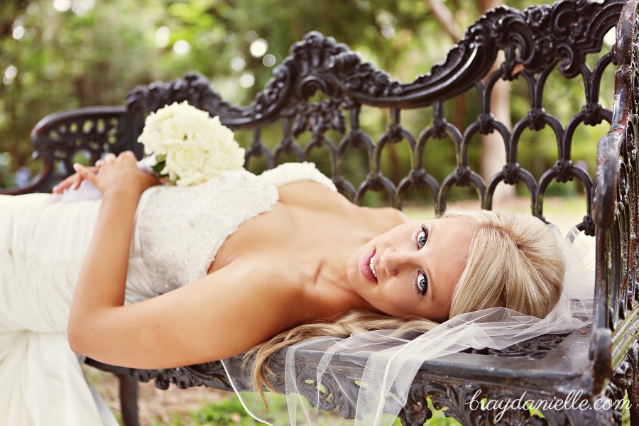 bride laying down on bench looking back at the camera by Bray Danielle Photography 