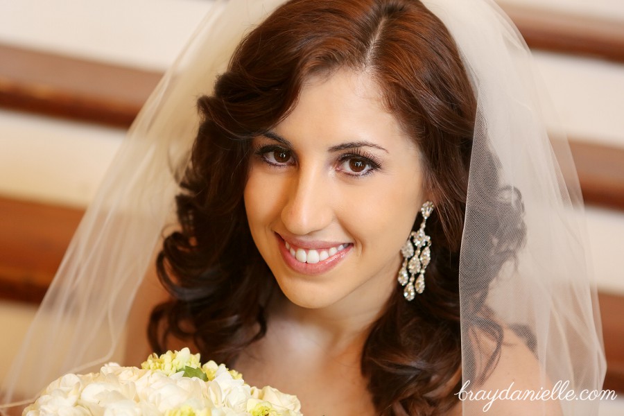 close up of bride with chandelier earings and white flowers by Bray Danielle Photography 